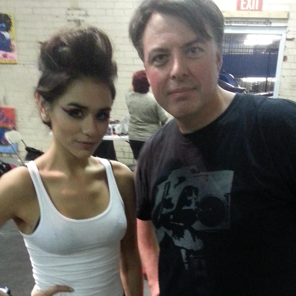 Christopher backstage with a model wearing a sculpted pompadour updo