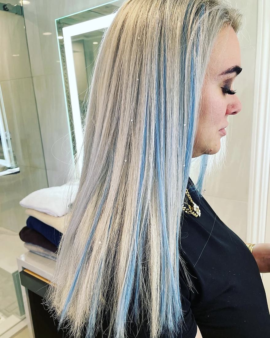 Long silver-blonde extensions with pastel blue streaks blended through