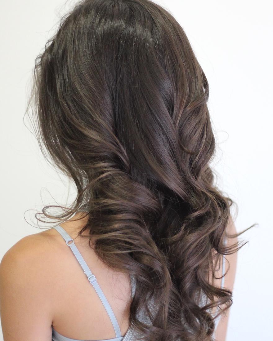 Long brunette hair in polished, voluminous waves