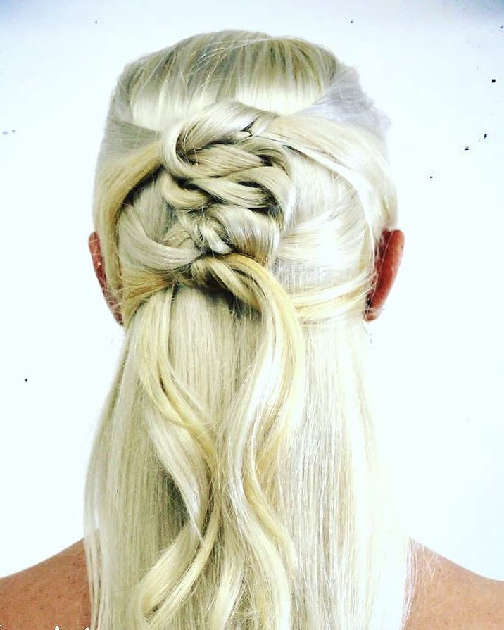 Platinum half-up style with a knotted braid and loose waves