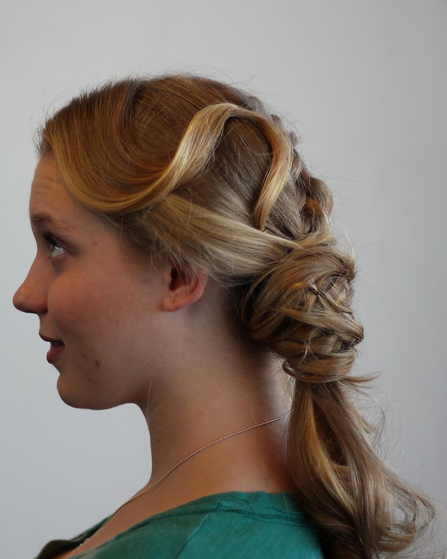 Side profile of a sculpted, curled blonde updo