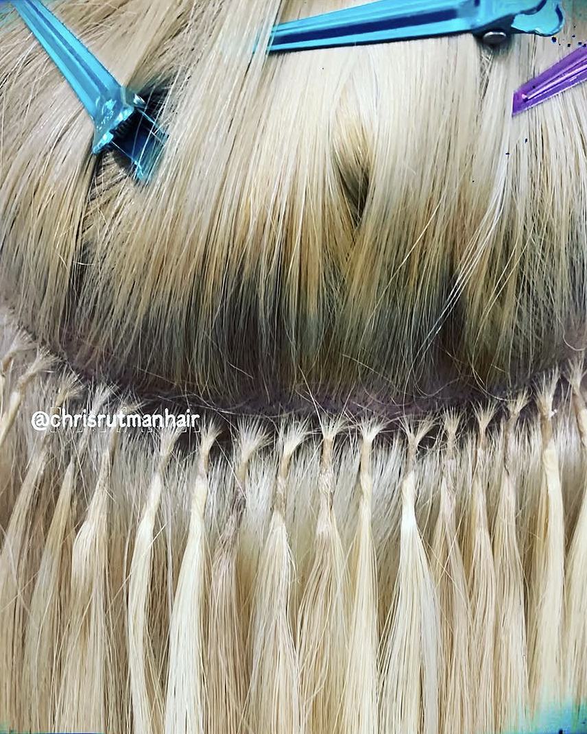 Close-up of a neat row of keratin-tip bonds in several shades of blonde
