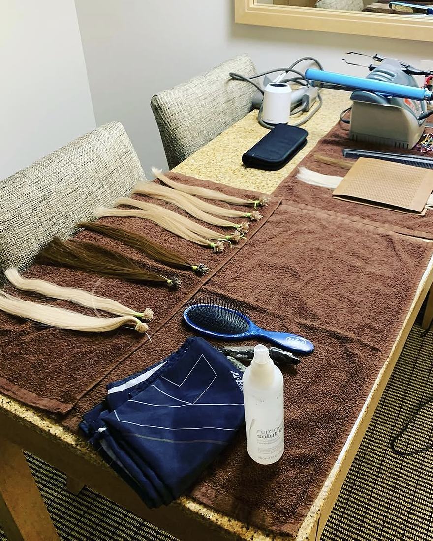 Keratin-tip extensions and tools laid out on a table, ready for a client