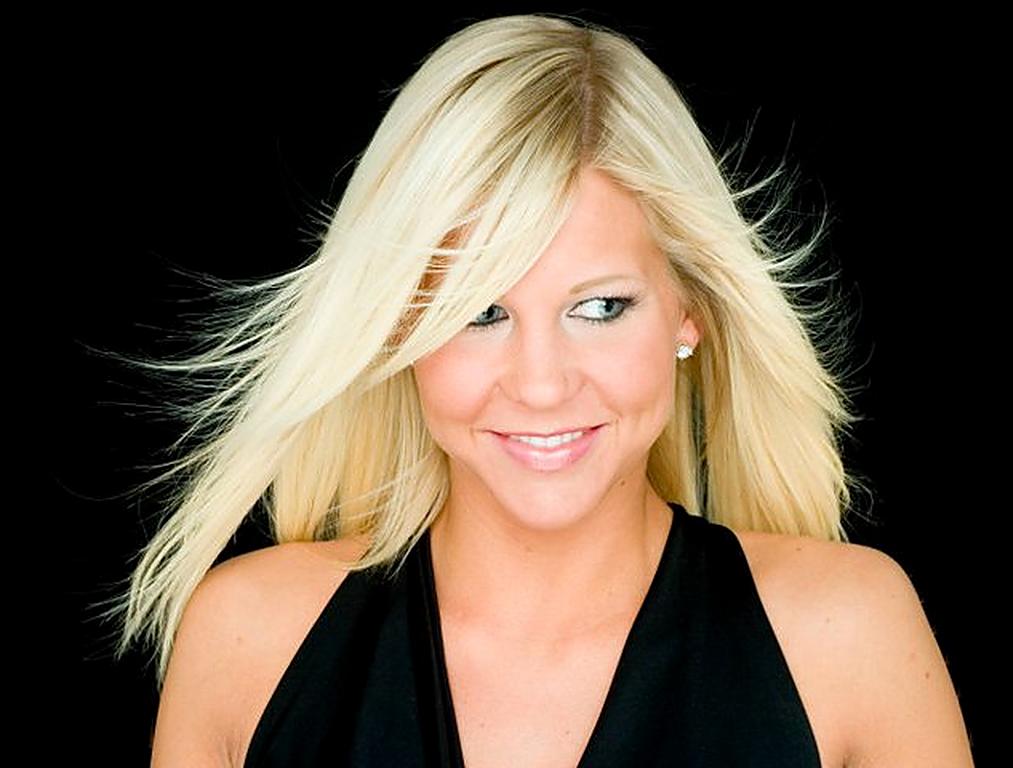 The client smiling, her long platinum hair in motion