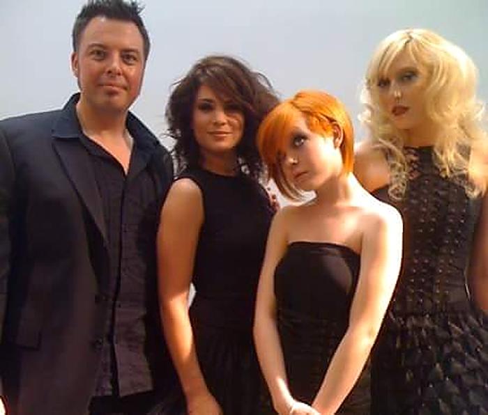 Christopher with three models wearing his finished cuts and colors